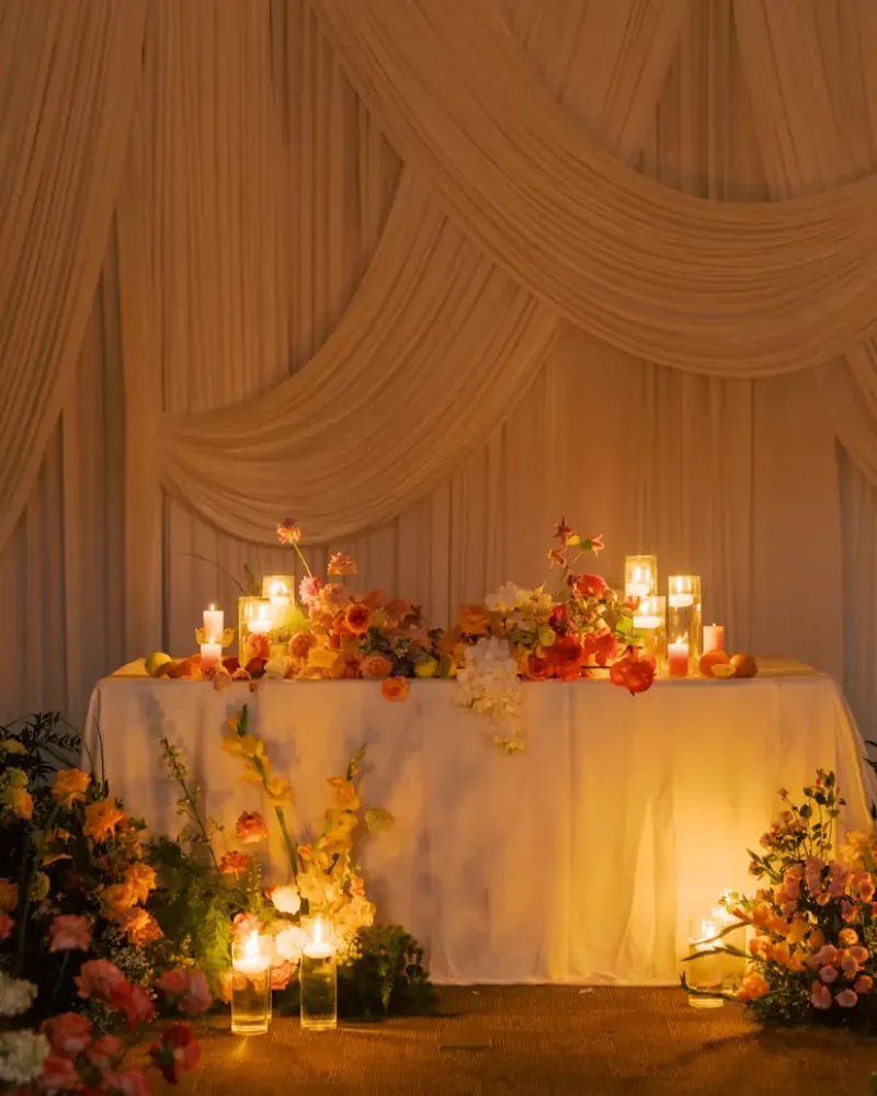A candle-lit wedding table where guests leave messages for the couple